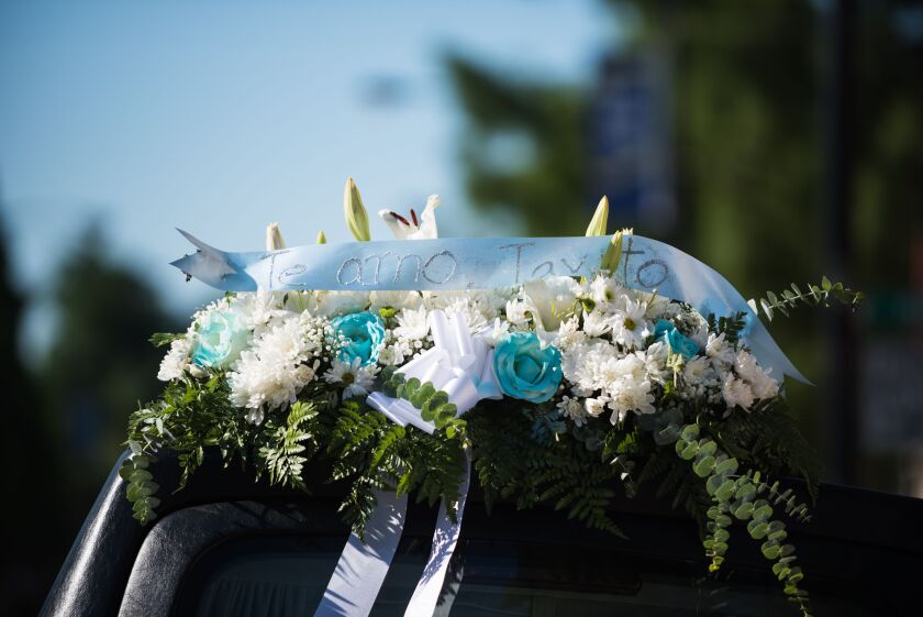 A bouquet of flowers for 10-year-old Gustavo Garcia sits on top of the hearse outside Immaculate Conception Church on Tuesday. | Max Herman/For The Sun-Times