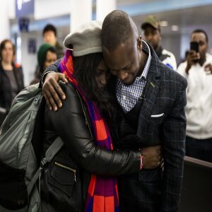 Celestine Mugisha and his wife, Winniefred Akello, embrace at O’Hare International Airport as they are reunited after living apart for more than three years, Jan. 22, 2020. Mugisha and Akello were married in Uganda in September 2016 and, days later, Mugisha moved to Chicago as part of the United States’ refugee resettlement program. More than three years later, Akello was also resettled through the program.