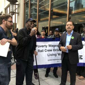 Clarence Hill, left, and Jesus “Chuy” Garcia speak at a rally for higher wages for railroad crew drivers Thursday, Sept. 27.| Rachel Hinton/Sun-Times