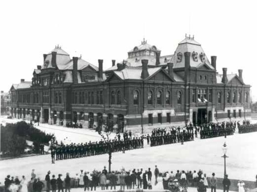 Pullman strikers outside Arcade Building in Pullman, Chicago, in 1894. The Illinois National Guard can be seen guarding the building during the Pullman Railroad Strike.