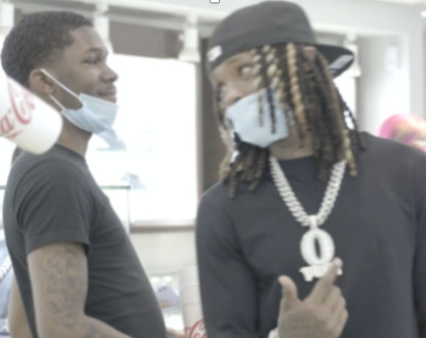 Marcus Smart (left), who’s charged in the killing of rapper FBG Duck, with King Von on Aug. 10, 2020. That was six days after the killing. Prosecutors say the image shows them shopping for diamond pendants at an Atlanta jewelry store.