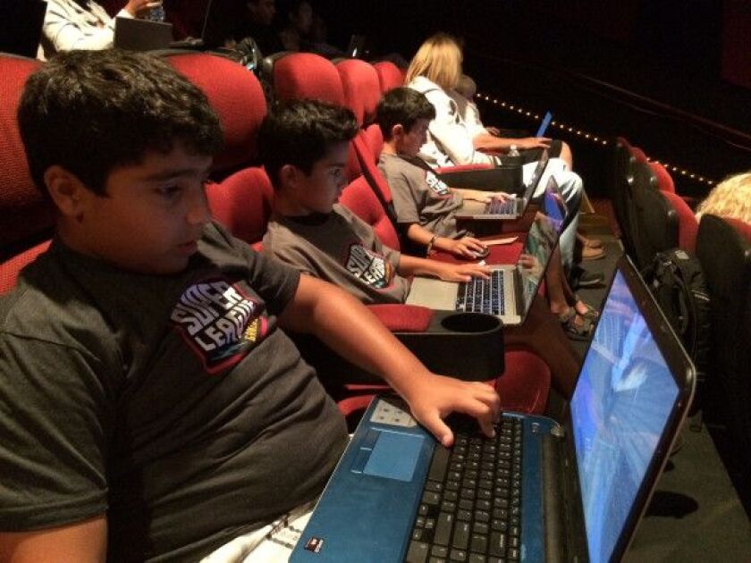 Lucas Ashorian, 11 (from left), Michael Ahsorian, 7, and Andrew Ahsorian, 9, of Lincolnwood, concentrate on their Minecraft gameplay at AMC River East on Tuesday, July 28, 2015. | MIRIAM DI NUNZIO/FOR THE SUN-TIMES