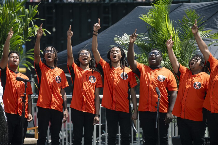 Members of Leo Excessive College Choir Mumble During the Archdiocese of Chicago's Celebration of Pope Leo XIV at Rate Area in June.
