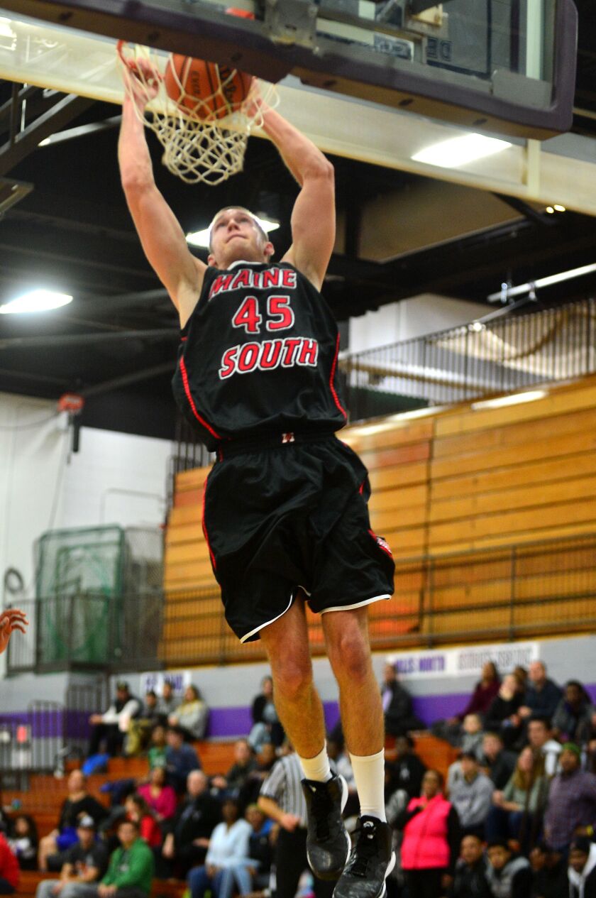 Maine South’s George Sargeant dunks against Niles North.