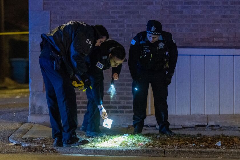 Police investigate the scene of a shooting in the 1000 block of 76th Street. | Photo by Tyler LaRiviere/Sun-Times.