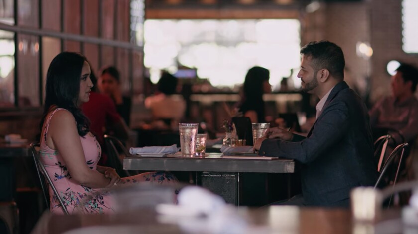 Two people sitting at a table.