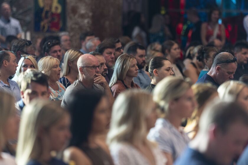 People in attendance listen to speeches by family members during a prayer service for CPD Officer Daniel Golden at St. Rita of Cascia Shrine Chapel on Thursday.