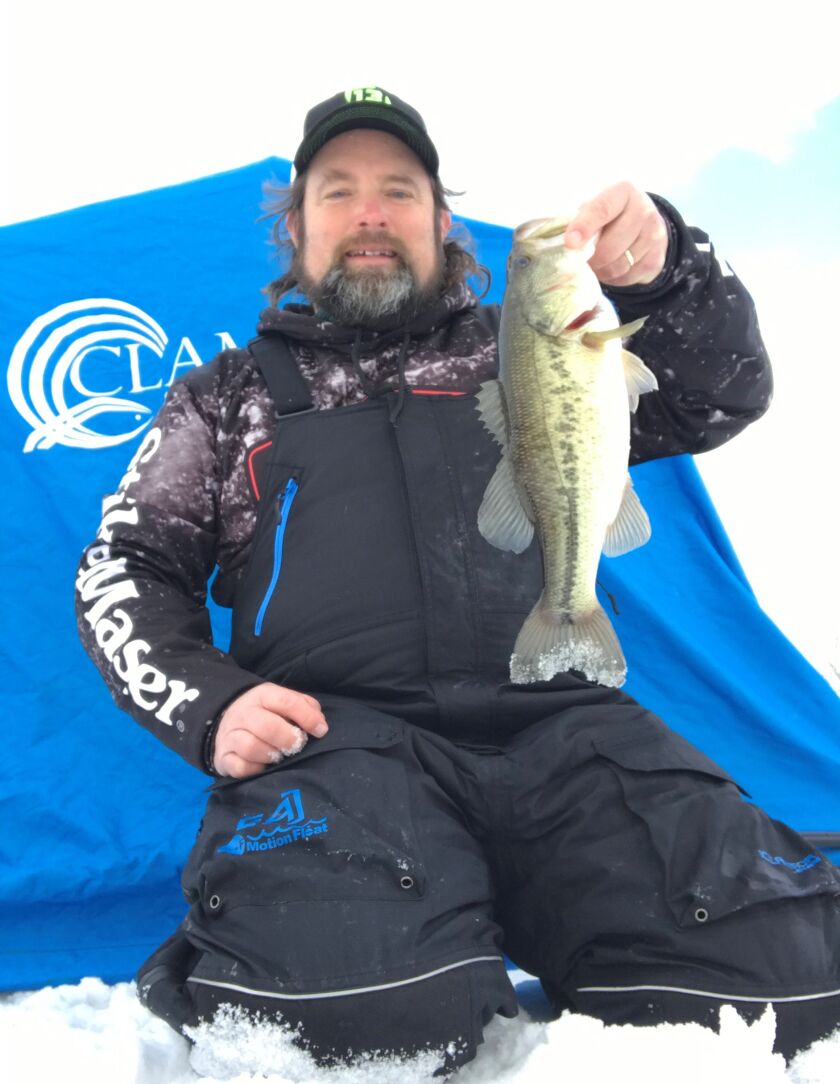 Ken “Husker” O’Malley with a largemouth bass caught ice fishing before the big snow. Provided photo