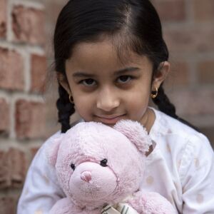 Maryam Rizvi, 5, sits with her stuffed teddy bear, Tuesday, April 28, 2020.