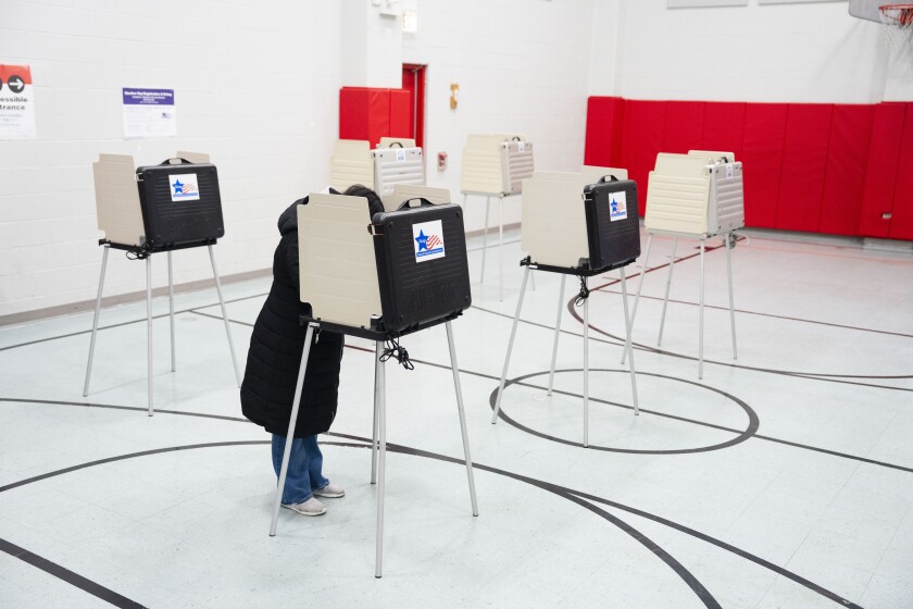 A person votes at George Rogers Clark Elementary School in Austin on Election Day, March 17.