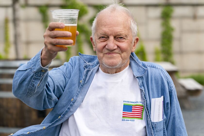 George Ripley, 72, of Washington, holds up his free beer after receiving the J & J COVID-19 vaccine shot earlier this month at the Kennedy Center in Washington.