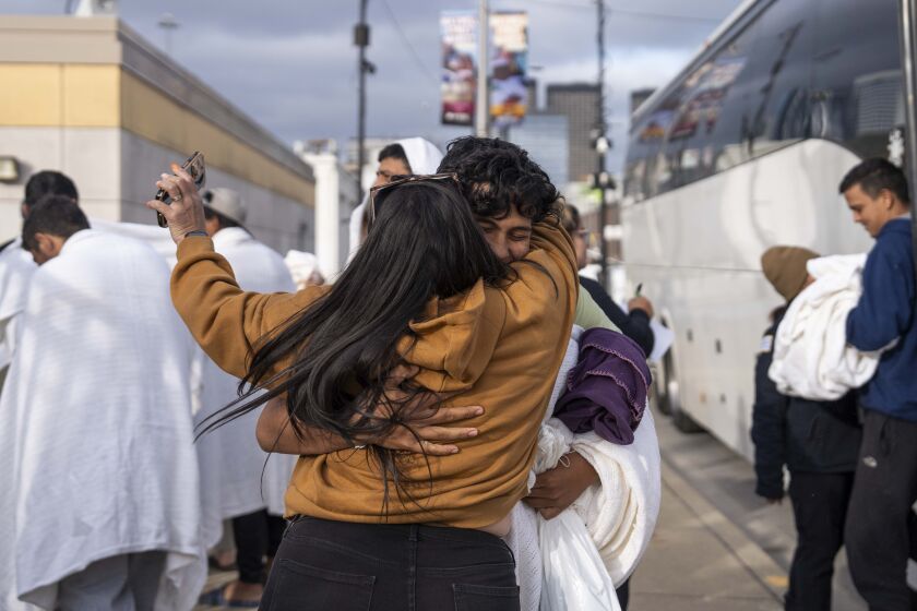 Eduardo Troconis meets his aunt, Lenny Troconis, who came from Indiana to meet her nephew, as he got off a bus at the city’s designated landing zone for migrant arrivals at 800 S. Des Plaines St. Staff from the Office of Emergency Management and Communications met asylum-seekers, who were getting off the bus, and they were provided with blankets and jackets.
