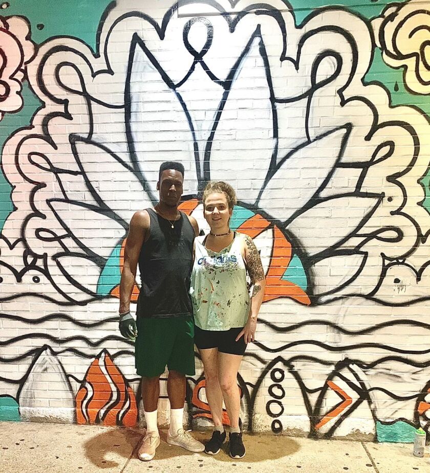CJ Williams (left) and Kristianna Jacques in front of the mural they painted last year outside a Rogers Park restaurant.