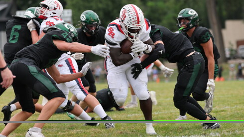 St. Rita's Brandon Johnson, carrying the ball, scores one of his touchdowns against Glenbard West.
