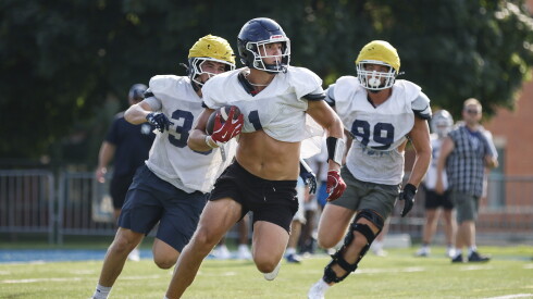 Nazareth’s Chris Kasky (1, center) carries the ball during practice.