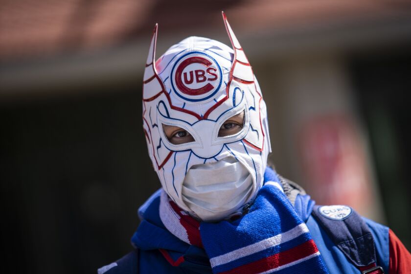 William Gonzalez, 40, of Gage Park, wears a Cubs-themed luchador mask outside Wrigley Field on Opening Day 2021.