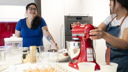 Author Mia P. Manansala (left) and Chicago Sun-Times Assistant Features Editor Dorothy Hernandez bake mocha “mamon,” one of Manansala’s recipes in her book, while chatting about her process at the Miele Experience Center Chicago at THE MART in River North, Wednesday, Nov. 12, 2025. | Pat Nabong/Sun-Times