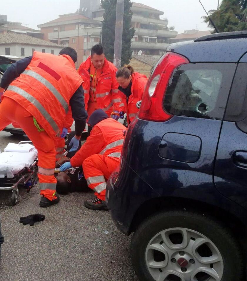 Italian Paramedics a wounded man after a shooting broke out in Macerata, Italy, on Saturday. | AP photo