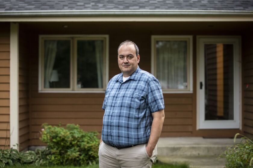 Jevon Bauman in front of his and his wife Karla Taylor-Bauman’s home in Lake Villa.