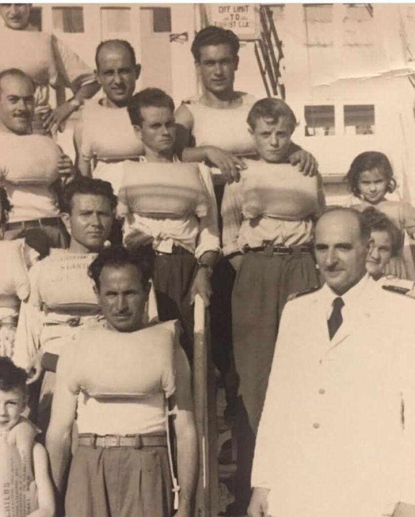 Anthony Gattuso (at top, with dark hair) on the boat that brought him to America in 1953. The seas were choppy, so the passengers frequently had to wear life jackets. | Provided photo