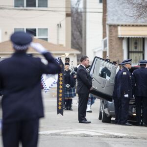 Officers salute the casket of Chicago Police Officer John P. Rivera. | Ashlee Rezin/Sun-Times