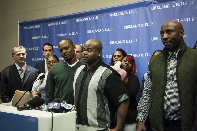 All charges against Lashawn Ezell, Charles Johnson, and Larod Styles (front, left to right) were dismissed in connection with a 1995 double murder and armed robbery. Here, the men appear at a news conference in 2017 after the charges were dropped. | Maria