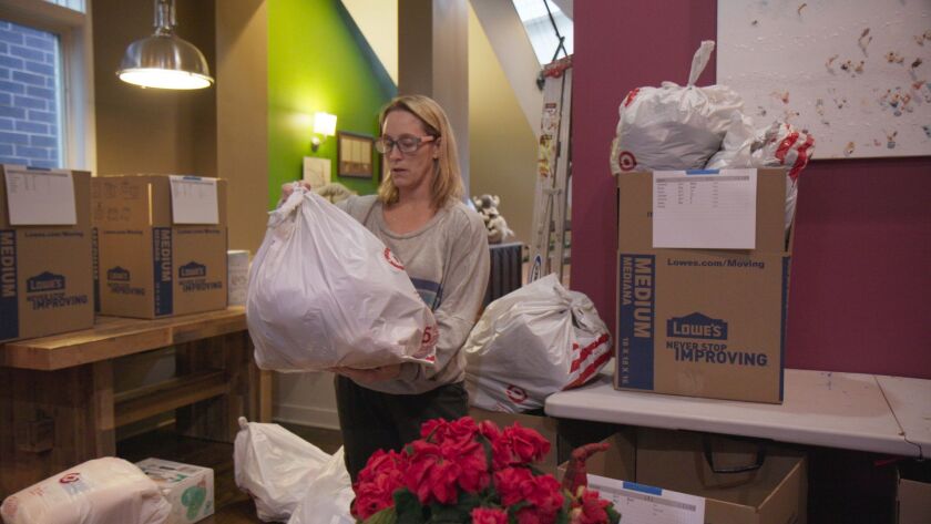 Jennifer Jones organizes holiday gift packages in her Bucktown home workshop in the documentary “Dear Santa.”