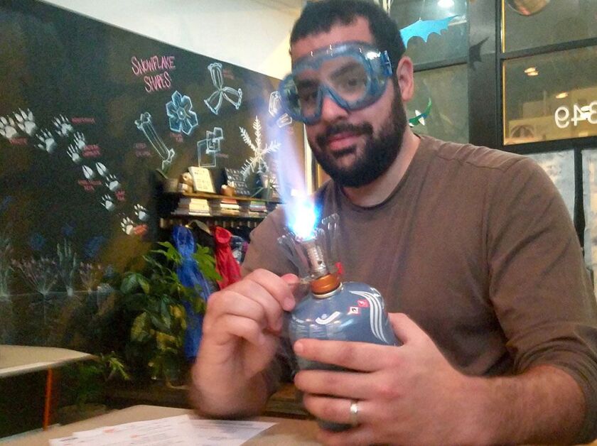 Erik Varga, a student at A Night At Hogwarts, lights a Bunsen burner for one of several experiments. | Courtesy of Amy Kang