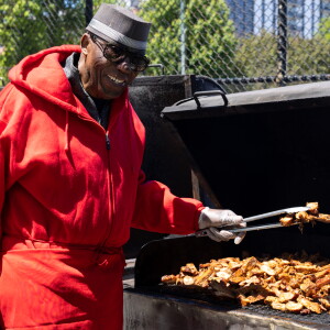 Robinson’s #1 Ribs owner tosses meat on the grill.