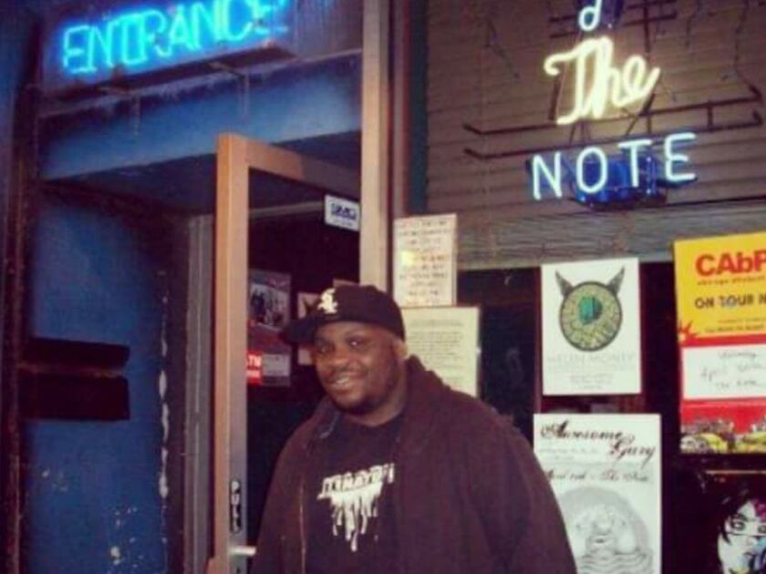 Chicago Sun-Times Digital Content Producer Evan F. Moore stands in front of one of the bars he worked at as a “doorguy.” | Supplied Photo