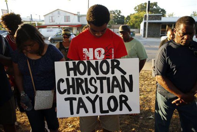 Jaylen McCray (center) participates in a vigil for Christian Taylor on Monday, Aug. 10, 2015, in Arlington, Texas. | G.J. McCarthy/The Dallas Morning News via AP