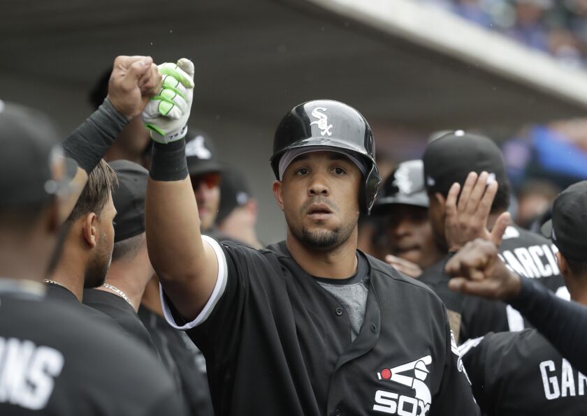 Abreu congratulated by teammates.