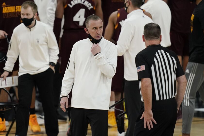 Arizona State coach Bobby Hurley speaks with an official during the first half of an NCAA college basketball game against Oregon.