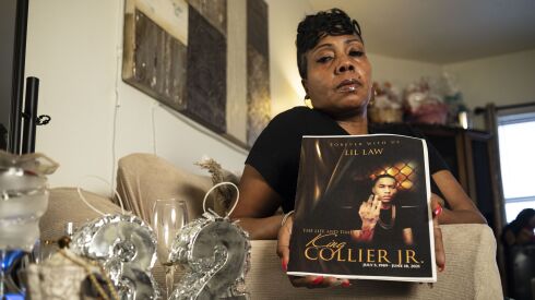 Erica Collier holds a portrait of her son King Collier Jr., who was killed in a driveby shooting outside the Parkway Gardens low-income housing project in June 2021. After nearly a year with no updates from detectives, Collier worries her son’s killing will never be solved.