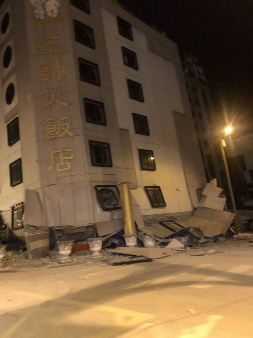 In this photo released by Hualien County Fire Bureau, debris around a building that collapsed onto its side following an early morning earthquake in Hualien County, eastern Taiwan, on Wednesday. | Hualien County Fire Bureau via AP