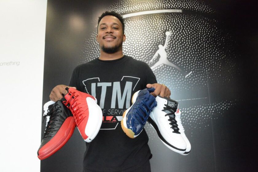 Gregory Smith, manager of Villa, holds some of the retro Jordans that will be re-released on Friday at Villa in the Englewood Square shopping center. | Brian Jackson/For the Sun-Times