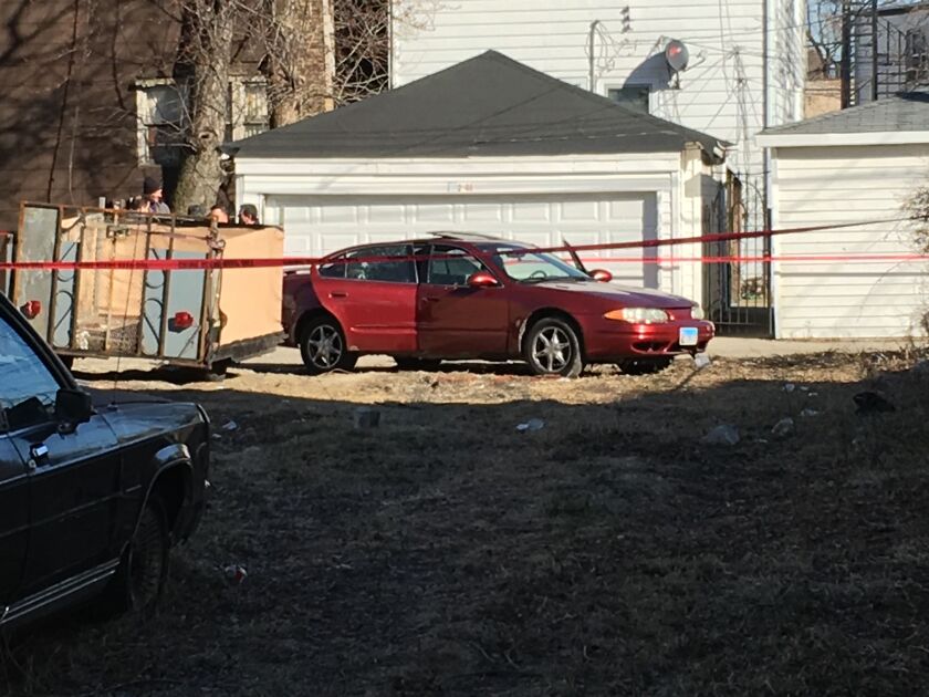 Police stand near a car in an alley between Kostner and Kenneth avenues while investigating the fatal shooting in North Lawndale. | Andy Grimm/Sun-Times