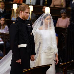 Britain’s Prince Harry and Meghan Markle stand, prior to the start of their wedding ceremony. | Dominic Lipinski/pool photo via AP