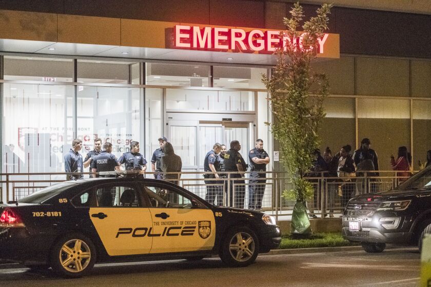 University of Chicago and CPD stage outside the University of Chicago Emergency entrance for crowd control. | Tyler LaRiviere/Sun-Times