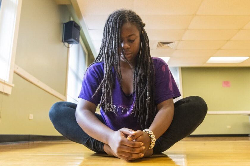 Aviwe DuBois of the Les Enfants Dance program stretches after practicing with others in the program, Saturday, Sept. 8, 2018, in Chicago. | Tyler LaRiviere/Sun-Times