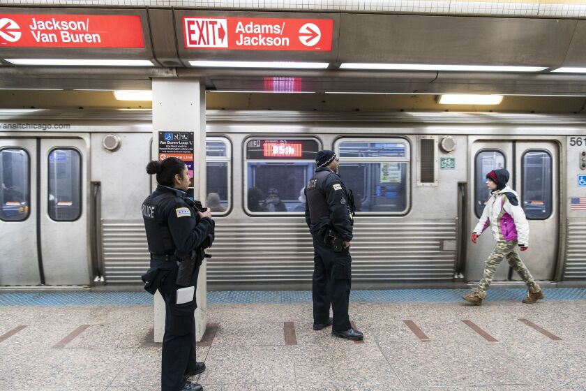 Two Chicago police officers patrol the Jackson Red Line platform.