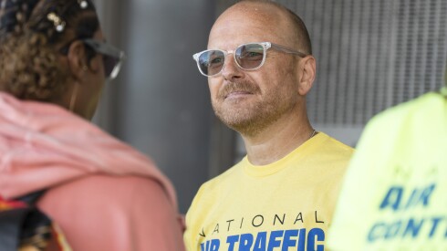 Matt Ellington, facility representative for the National Air Traffic Controllers Association Local ORD, speaks to a reporter as members distribute flyers about how the government shutdown is affecting air traffic controllers’ livelihood and aviation efficiency and safety at O’Hare International Airport, Tuesday, Oct. 14, 2025.