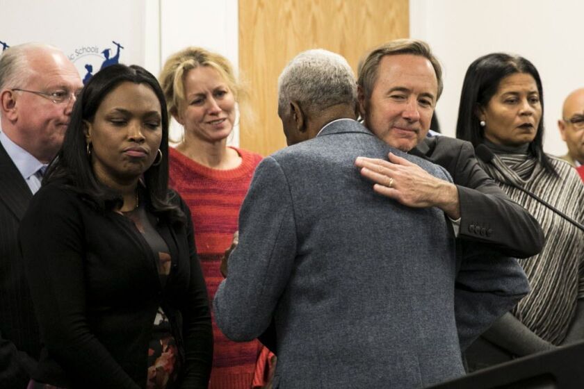 Chicago Public Schools CEO Forrest Claypool hugs Leon Finney Jr., who spoke in support of Claypool after his resignation was announced at a news conference at CPS headquarters on Dec. 8. | Ashlee Rezin / Sun-Times
