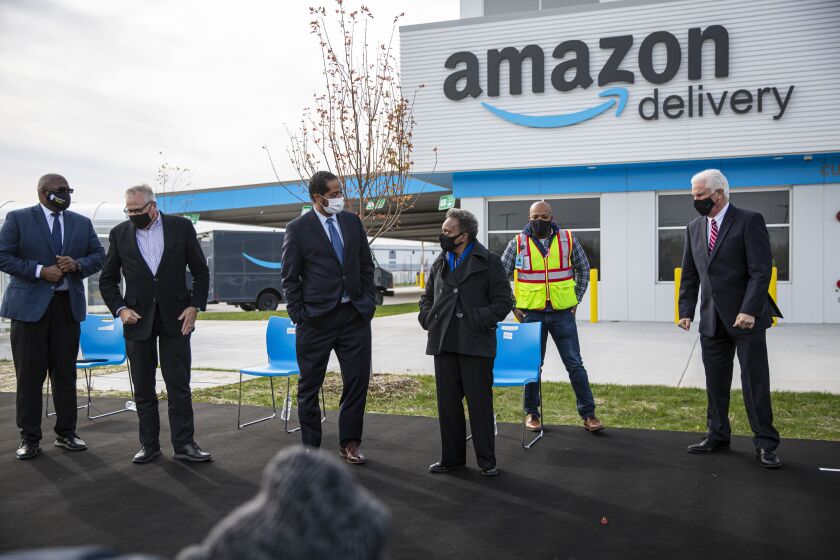 Ald. Anthony Beale (9th), left, and Mayor Lori Lightfoot, greet one another at the opening ceremony of Chicago’s first Amazon Delivery Station at 10500 S. Woodlawn Ave in Pullman, Wednesday, Oct. 28, 2020.