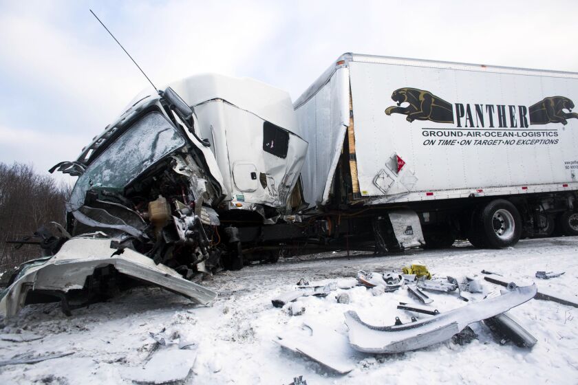 <small><strong>Road crews work to clear wrecked vehicles and debris along Interstate 94, Saturday, Jan. 10, 0215, the day after a series of crashes closed the highway between mile markers 88 and 92 in eastern Kalamazoo County, near Galesburg, Mich. The nu