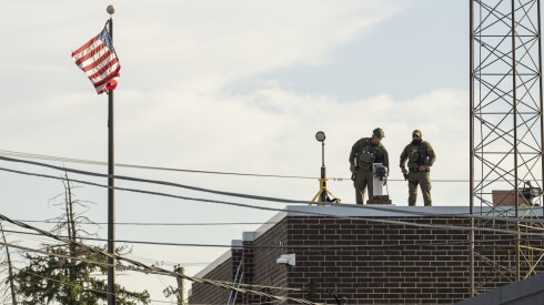 Federal law enforcement agents stand on top of the Broadview ICE processing facility in suburban Broadview, Thursday, Oct. 2, 2025.