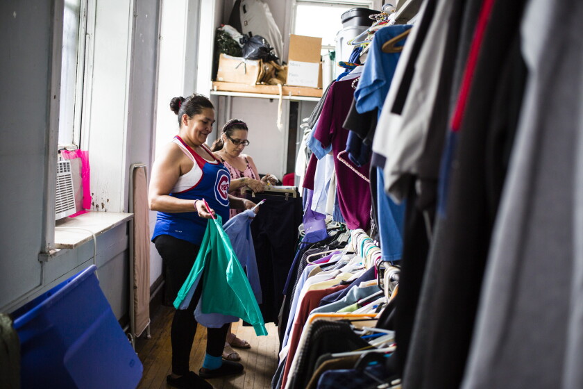 Volunteers put away clothes at the God's Closet thrift store operated by First Lutheran Church of the Trinity in Bridgeport in 2019.