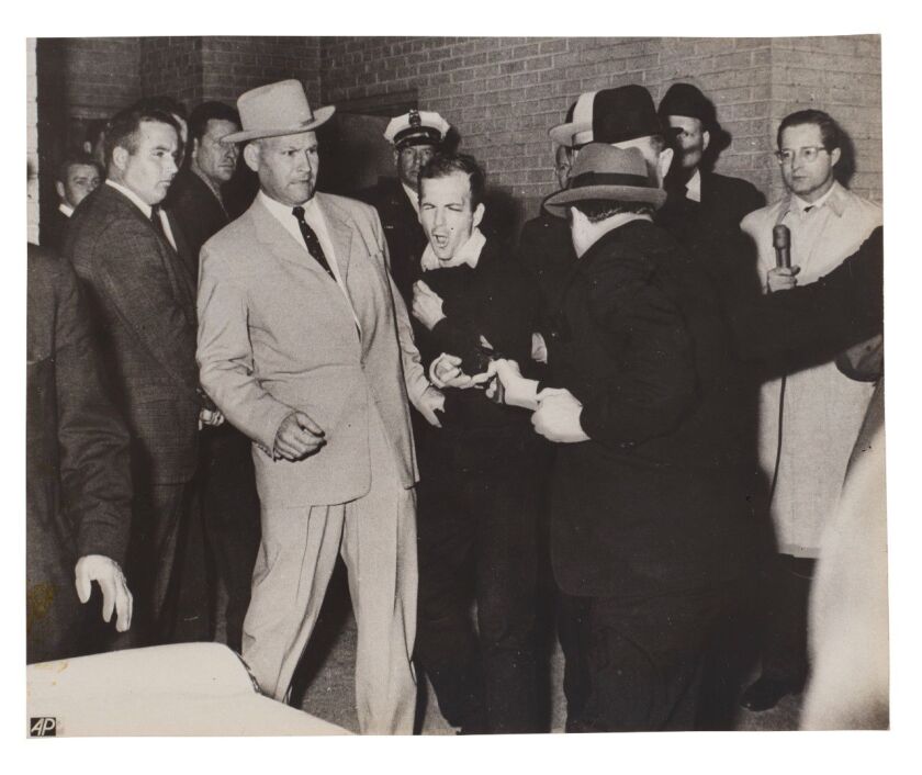 In this Associated Press photo, nightclub owner Jack Ruby fatally shoots Lee Harvey Oswald, who assassinated President John F. Kennedy. This photo is among a collection of photos taken at the time of the assassination in November 1963 in Dallas.