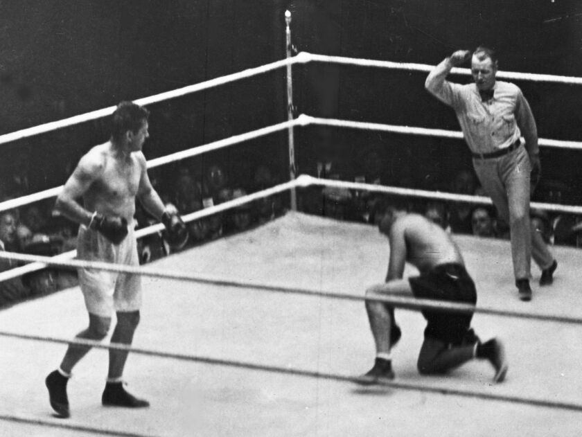 This Sept. 22, 1927 file photo shows Jack Dempsey going down on one knee during his heavyweight title fight against Gene Tunney, in Chicago. Tunney’s unusual life of boxing and books will be on display on Thursday in an auction of his memorabilia by Sothe