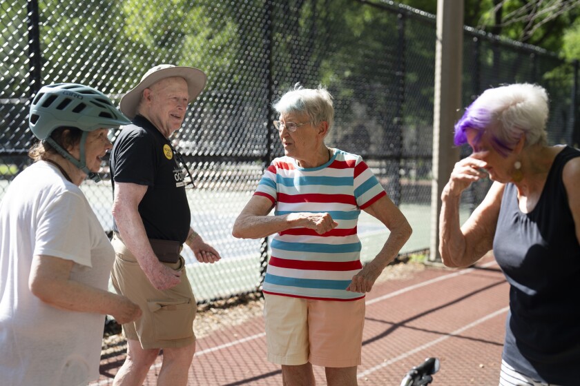 Sandra Brown (left) and Susan Ackerman greet their friends at Lake Park in Streeterville, where they usually exercise and socialize, Monday, June 23, 2025.